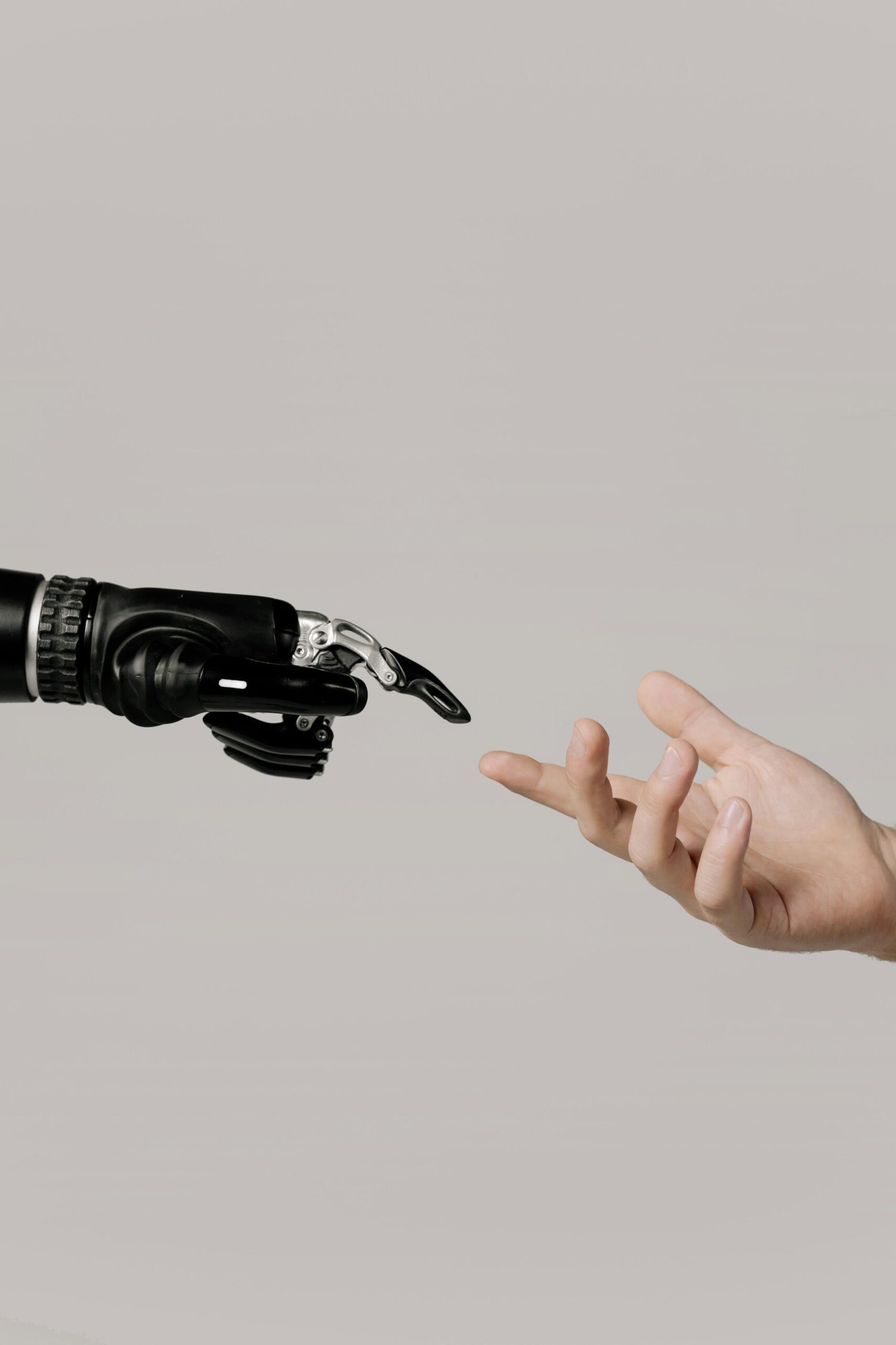 Robotic and human hand symbolizing AI-human collaboration in HR